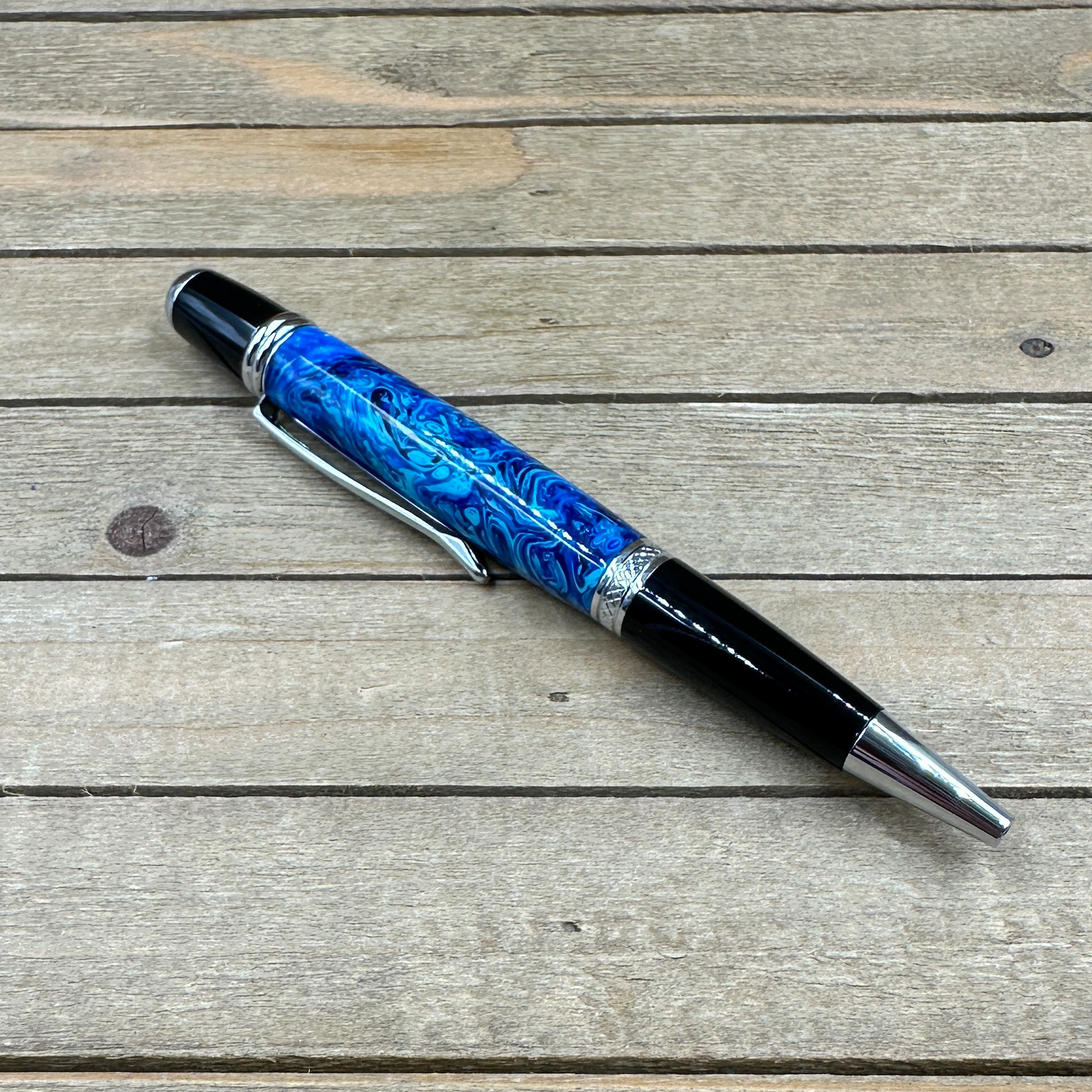 Multiple hues of blue resin on a chrome ballpoint pen Multiple hues of blue resin on a chrome ballpoint pen