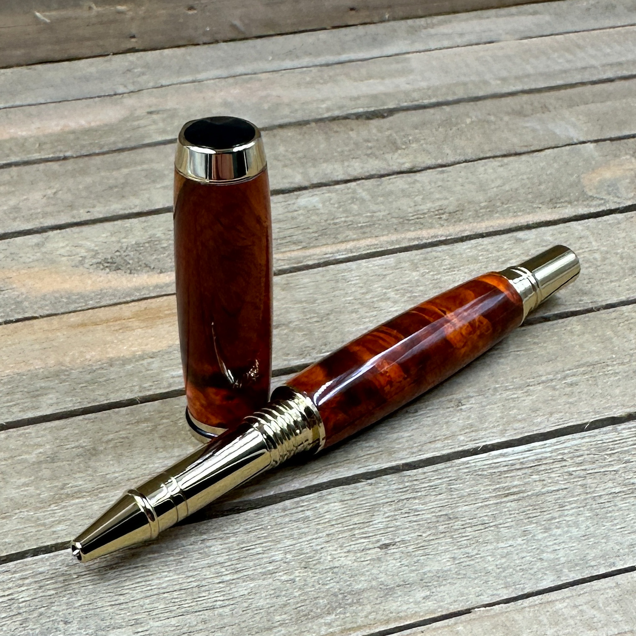 Red and brown colored burl wood with gold hardware  Red and brown colored burl wood with gold hardware